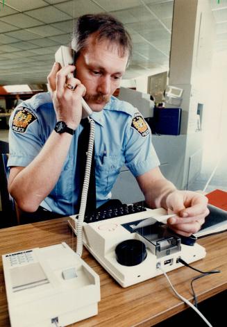 New technology: Peel Region Constable Robert Bamlett uses new equipment which will enable deaf residents to report emergencies to police more quickly and efficiently
