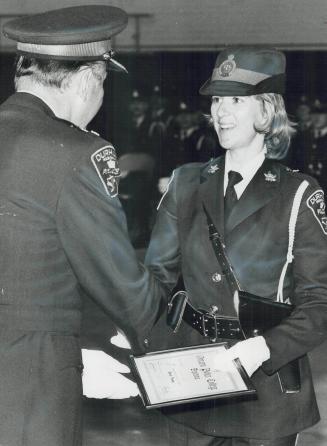 Only woman in graduation class of 21 Durham Regional Police recruits, Constable Nancy Desjardins receives her diploma from Deputy Chief Thomas Chamber(...)