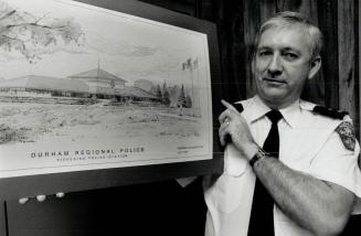 Jim Fishley, a Durham police inspector, shows architect's sketch of Pickering station