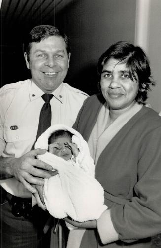 Happy beginning: Mississauga policeman Jeff Lavigne and mom Kowsilla Balgobin proudly show off baby Andy at Etobicoke General Hospital yesterday