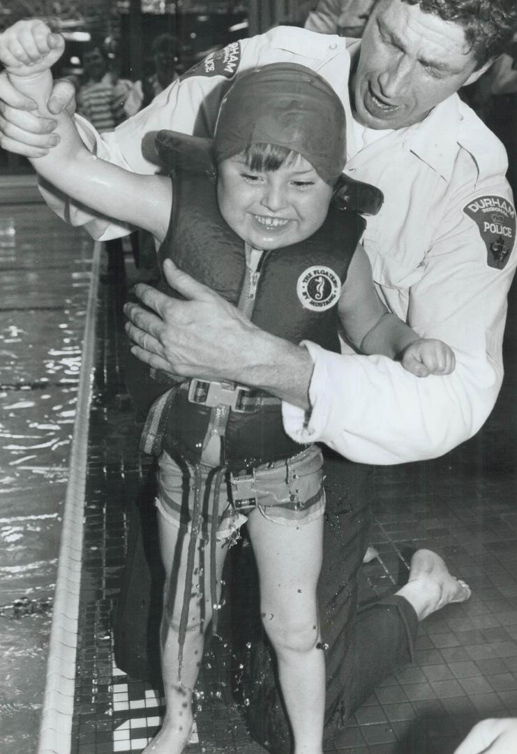 In swimming style, Six-year-old Thomas Bird is all smiles yesterday after competing in the 7th annual Durham Regional Police Disabled Children's Games(...)