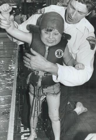 In swimming style, Six-year-old Thomas Bird is all smiles yesterday after competing in the 7th annual Durham Regional Police Disabled Children's Games(...)