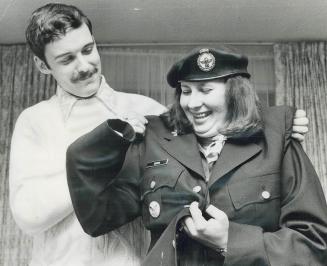 First female Mountie, Heather Ann Phyllis, 21, looks a little lost in the uniform belonging to her husband-to-be Glenn Souva, also 21. Heather will be(...)