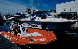 Long arm of the law on Lake Ontario, RCMP Constable Ray Usarewicz, in the foreground, and Sergeant Mark Crawley of Peel Regional Police Marine Unit, C(...)