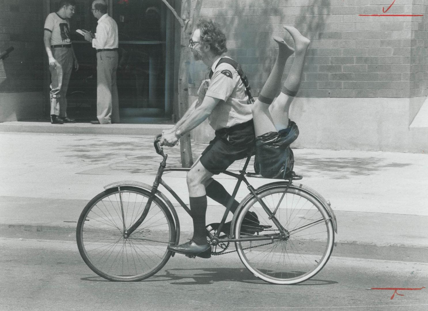 Bicycle built for 1 1/2 This postman ? he wouldn't give his name ? wasn't really delivquin legs for a sculpture and had to take them home on his bike ? turning a few heads in the process