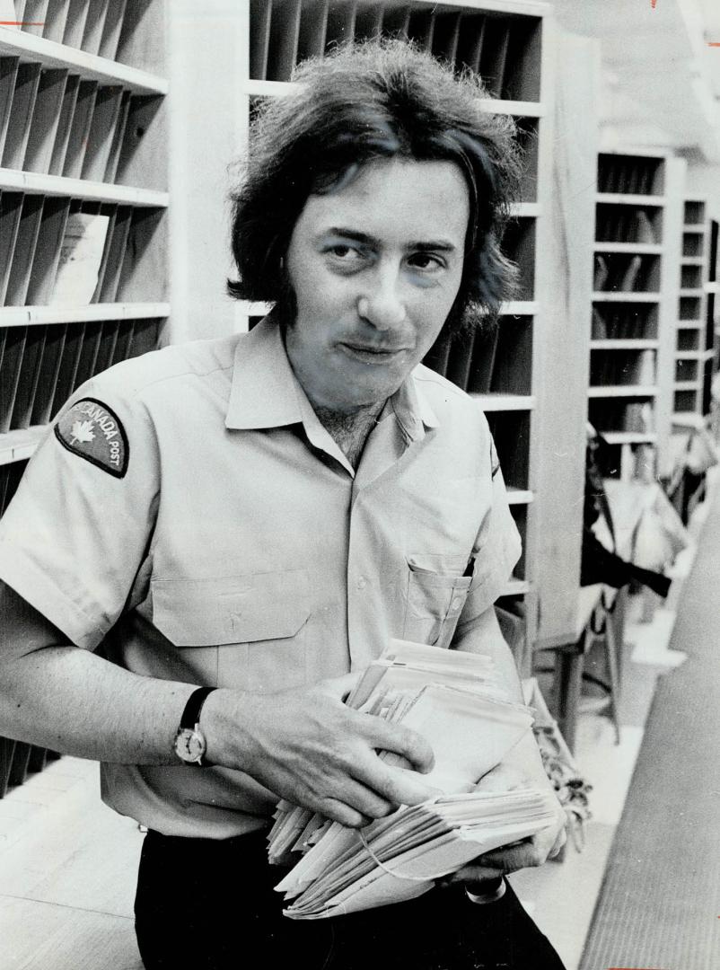 Poet Postman Bob Flanagan picks up mail before going out on his rounds in Thornhill
