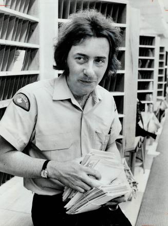 Poet Postman Bob Flanagan picks up mail before going out on his rounds in Thornhill