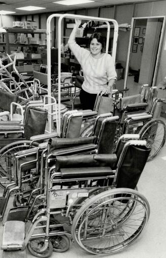 How about a seat: Lorraine Slater is shown with some of the wheelchairs that are loaned out as part of the equipment program at the Scarborough branch of the Canadian Red Cross Society