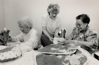 Helping hands, Red Cross Sewing group members work on crafts they sell under the Creations label to raise money for domestic and foreign aid programs.(...)