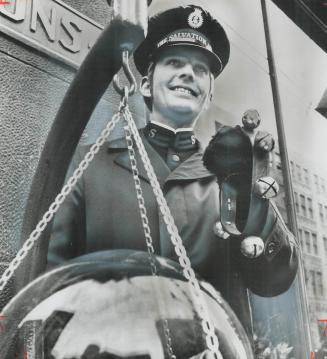 Christmas cheer goes into the Salvation Army kettle with the encouragement of Sally Ann cadet Ted Palmer-even if he has to sing a Christmas carol off-(...)