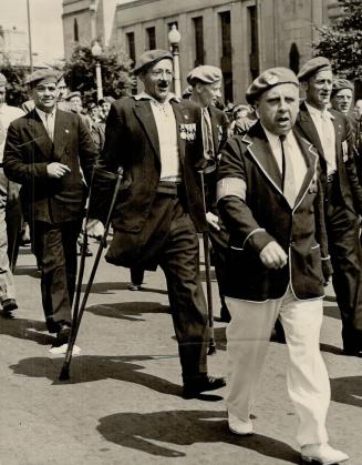In wheeled chairs and some on crutches (left) veterans marched again with their units in the reunion parades