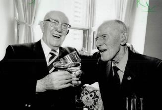 To a long life: world war I veterans Dick Ellis, 96, left, and Billy Richardson, 98, share a toast from a bottle of 1937 champagne that was put away for the last two survivors of a battalion