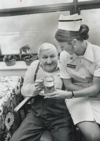 At the new bar for some elderly patients in Sunnybrook Hospital, Alfred Last lifts his glass with nurse Gail Dailley