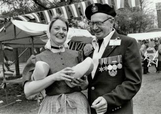 Abeldoorn - The Netherlands Yvonne Lieferink dressed in Dutch costume with Klompen (wooden shoes) showing one of them to Gordon McKerrell - Toronto (Cameron Highlanders, Ottawa)
