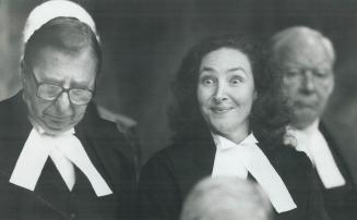 Madam Justice Rosalie Abella, standing beside Chief Justice Charles Dubin, mugs for her family yesterday as she is sworn in as a judge of the Court of(...)