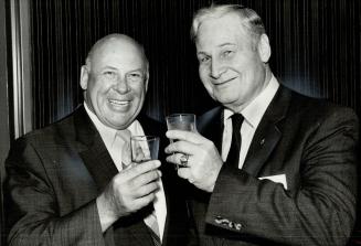 Congratulations: Police Chief Harold Adamson (right) toasts his successor, Deputy Chief Jack Ackroyd, after announcing retirement as head of the 6,000-member department