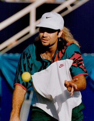 Sartorial Gaudiness: A bejewelled Andre Agassi makes a loud fashion statement yesterday during his one-sided match at the Player's International