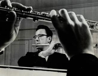 Flautist Robert Aitken, Practising his playing in front of a mirror