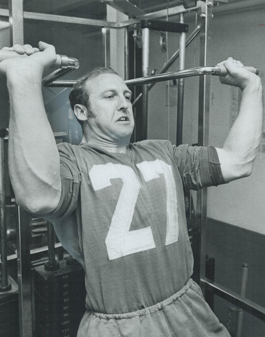 Heave-Ho! Dick Aldridge strains as he pushes weights in Argonaut Rowing Club's gymnasium