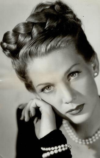 Lousie Albritton is another of the Hollywood folk who likes a streamlined type of coiffure