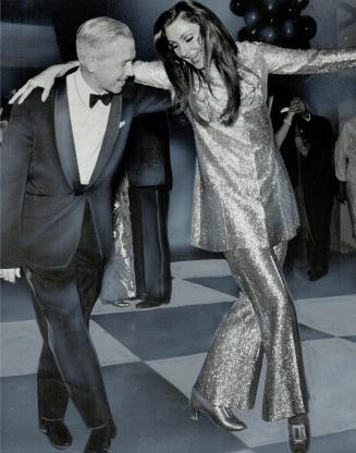 Meet Zobra the Canadian, Metro Chairman Bill Allen gets some lessons in Greek dancing with Miranda Zafiropoulou --- Miss Greece '68 --- clad in shimme(...)