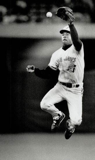 Robbie Robbery: Jays second baseman Robbie Alomar goes high into the air to snag this ball in Toronto's 5-4 win over the Brewers last night at SkyDome