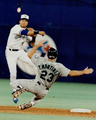 Jays second baseman Roberto Alomar turns a double play with his usual ease as Seattle's Tino Martinez tries to breakit up last night at the dome