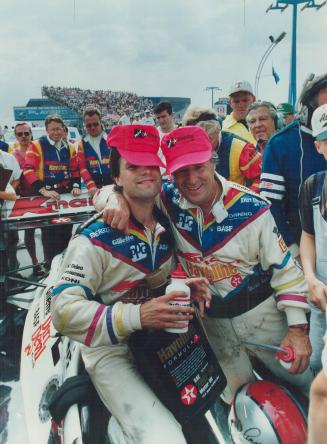 Mario Andretti hugs his son Michael after finishing second to the younger Andretti in the Indy yesterday in front of 61,264 sweat-soaked fans at Exhib(...)