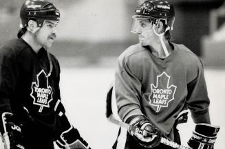 Getting some tips: Rookie Tim Armstrong, right, who has been called up from Newmarket to play for the Leafs tonight, listens to injured Wendel Clark during practice yesterday