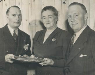 P. J. Cowan presents tray to Lady Baillie. Oakville, May 19-The Oakville Lions club last night presented its annual award of merit to Lady Baillie for(...)