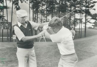 One pro to another: PGA Seniors' tour member Al Balding of Toronto steadies the swing of hockey great Bobby Orr during yesterday's Nabisco pro-am at Glen Abbey