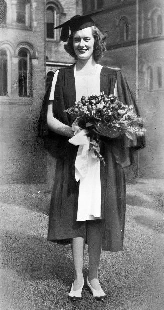 Eleanor (Reed) Gartshore, in graduation gown, University College quadrangle, University of Toronto