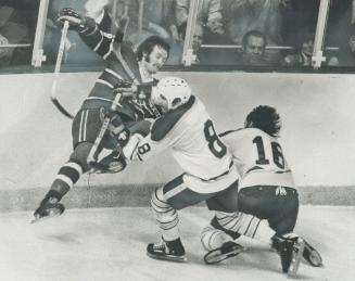 Heading for fall, Montreal Canadiens' defenceman Larry Robinson grimaces as he collides with Jim Lorentz (8) of Buffalo Sabres in last night's fifth g(...)