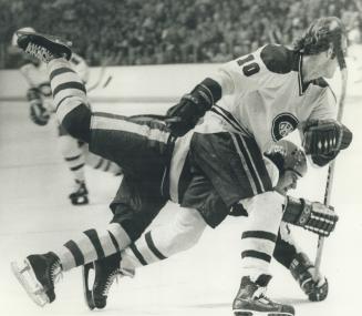 Montreal's Guy Lafleur skates past Jimmy Jones during their first semi final game here 5/2