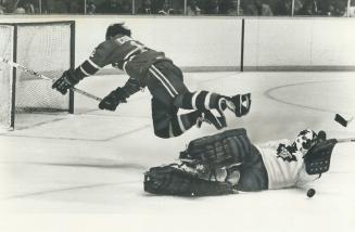 A beleaguered Maple Leaf goalkeeper Mike Palmateer was all alone here, as he was much of the night, fending off a breakaway as he foiled Yvan Cournoyer