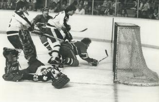 Cam Connor (20) wound up on the ice but not before he put a trickler behind Maple Leafs goaltender Mike Palmateer to give the Canadiens a 4-3 overtime victory