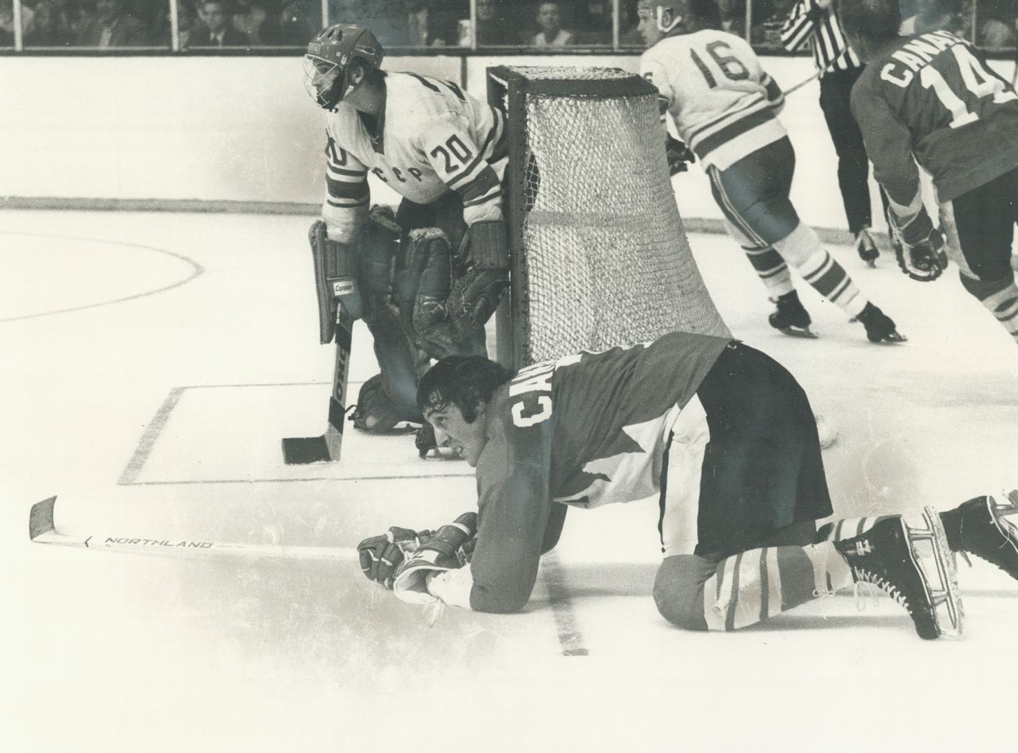 Boston Bruins' sensational scorer Phil Esposito (on knees) has been tripped, but his eye is still on puck during third period of last night's Team Can(...)