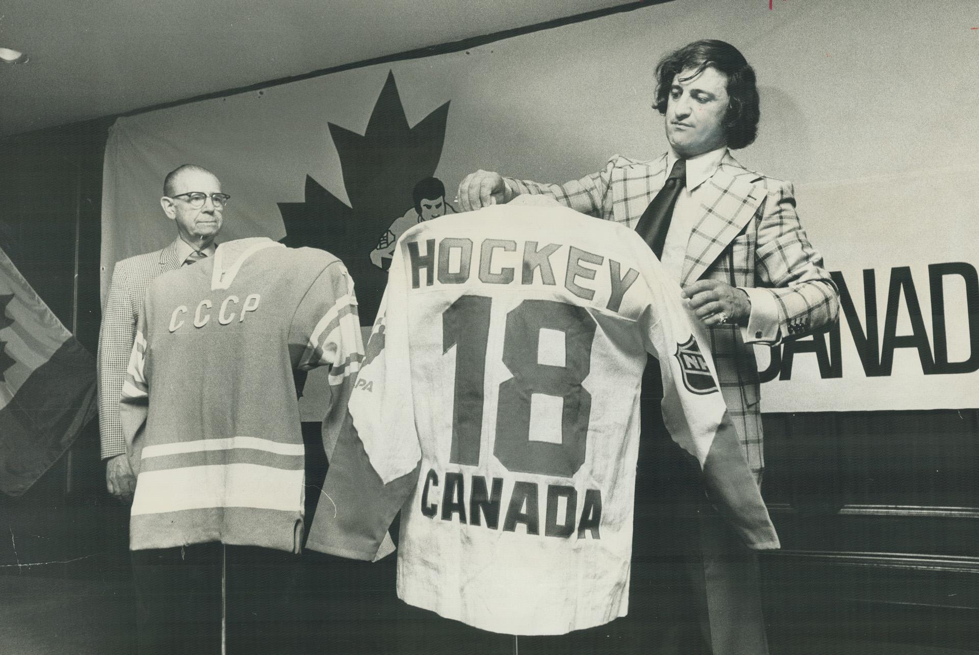 Paul Henderson admires Team Canada sweater after he was named