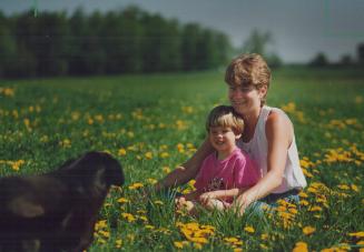 Rural bliss: Lori Wade, daughter Carly, 4, and dog Suzie unwind at the Seagrave family farm