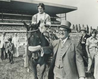 Delighted owner J. Louis Levesque of Montreal leads Queen's Plate winner L'Enjoleur and jockey Sandy Hawley to winner's circle at Woodbine Saturday. I(...)