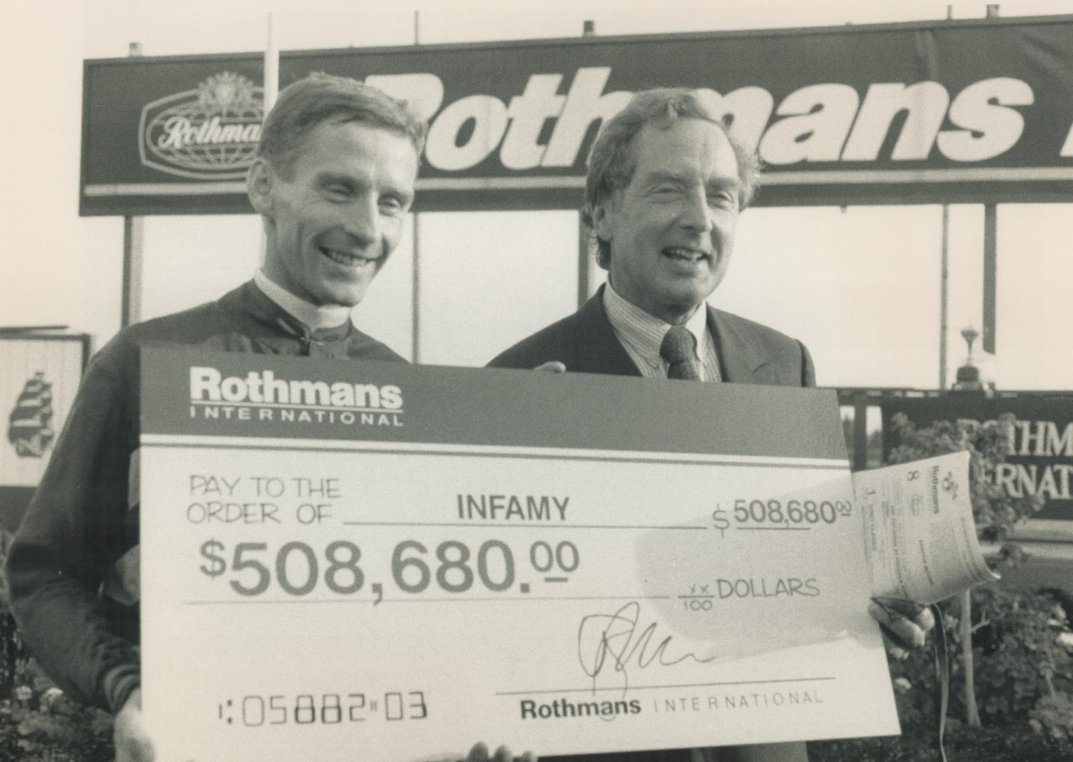 They're in the money: Jockey Ray Cochrane, left, and owner Edward Leigh were all smiles yesterday after infamy's big win in the International at Woodbine
