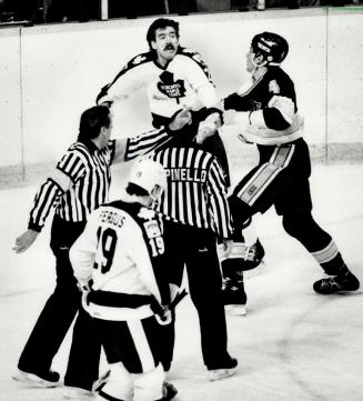 Into the fray: St. Louis tough guy Charlie Bourgeois wades into battle against Toronto's Brad Smith, while Tom Fergus, referee Bob Myers and linesman (...)