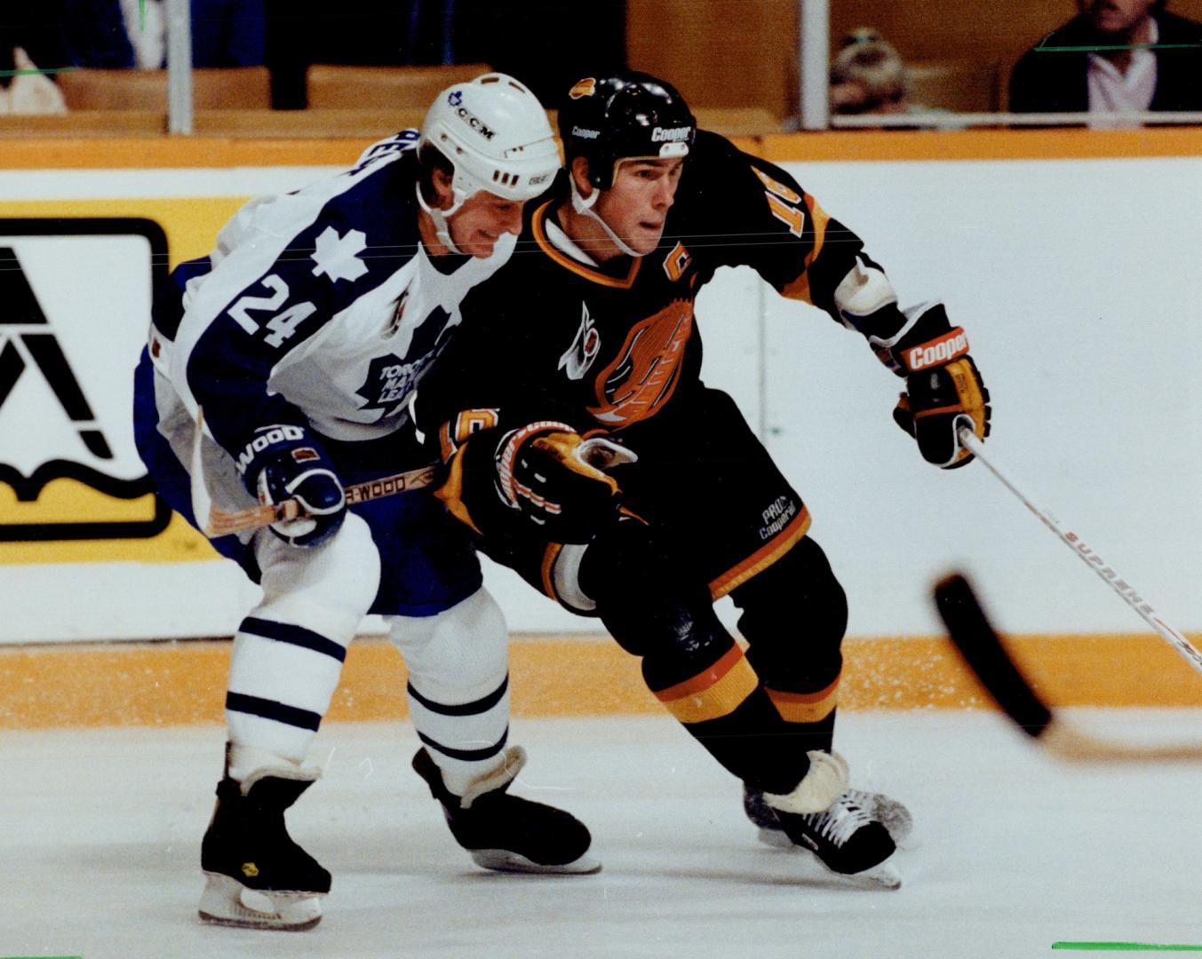 Shoulder to shoulder: Leaf defenceman Michel Petit tries to restrain Trevor Linden, whose shorthanded goal gave the Canucks a 2-1 win at Gardens