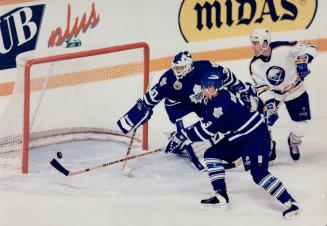 Follow the bouncing puck. Leafs goaltender Rick Wamsley and defenceman Bob Rouse react too late to prevent this Alexander Mogilny shot from finding th(...)