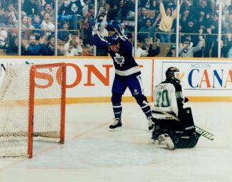 Let the good times roll: The Leafs' Dave Hannan celebrates as another puck finds its way past Jon Casey and into the North Star net last night at the Gardens