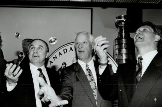 In mint condition: Former Leafs Ron Ellis, left, and Darryl Sittler, right, join hockey legend Gordie Howe at a ceremony to unveil a silver dollar commemorating the Stanley Cup's 100th anniversary