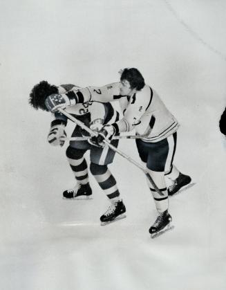Phil Esposito charges at leaf. Toronto's Brian Glennie hit from behind