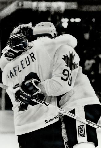 Great while it lasts: A few weeks from now, Guy Lafleur and Wayne Gretzky will be opponents again, but they're having fun now celebrating Team Canada goals, like Wayne's second last night