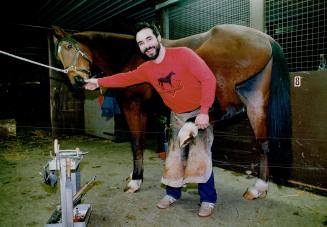 Happy days: Farrier Bob Scott gives Lucky new shoes