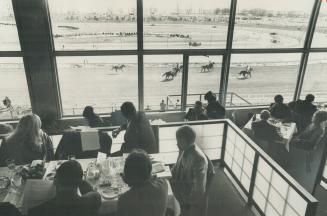 They're off and dining at the Terrace Dining Room at Greenwood racetrace yesterday as they watch the horses race past the huge picture window. The 197(...)